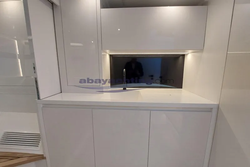  Yacht Photos Pics 2024 VanDutch 48 yacht interior with sleek white cabinetry and modern design.