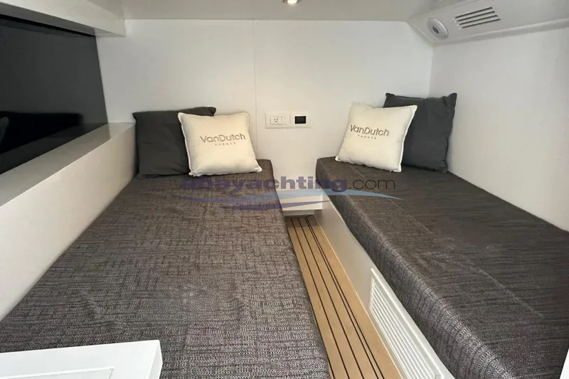  Yacht Photos Pics 2024 VanDutch 48 yacht interior cabin with twin beds and branded pillows.