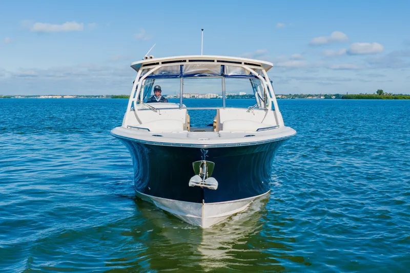  Yacht Photos Pics 2013 Grady-White Freedom 335 boat on calm blue water under clear sky.