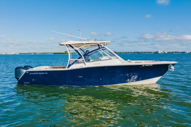 Yacht Photos Pics 2013 Grady-White Freedom 335 boat on calm water under clear blue sky.