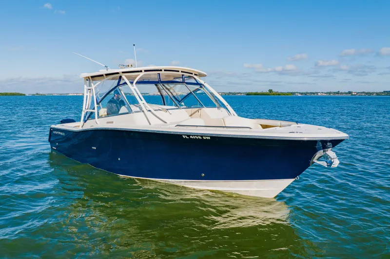  Yacht Photos Pics 2013 Grady-White Freedom 335 boat on calm blue water under clear sky.