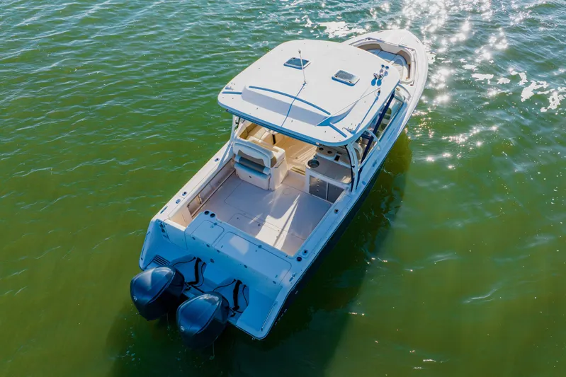  Yacht Photos Pics 2013 Grady-White Freedom 335 boat on sparkling water, aerial view.