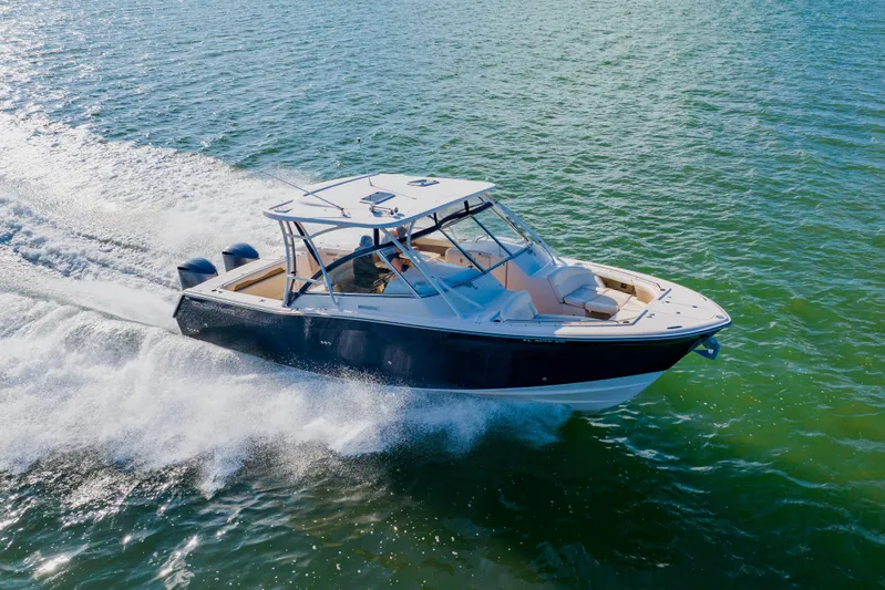  Yacht Photos Pics 2013 Grady-White Freedom 335 boat cruising on open water.