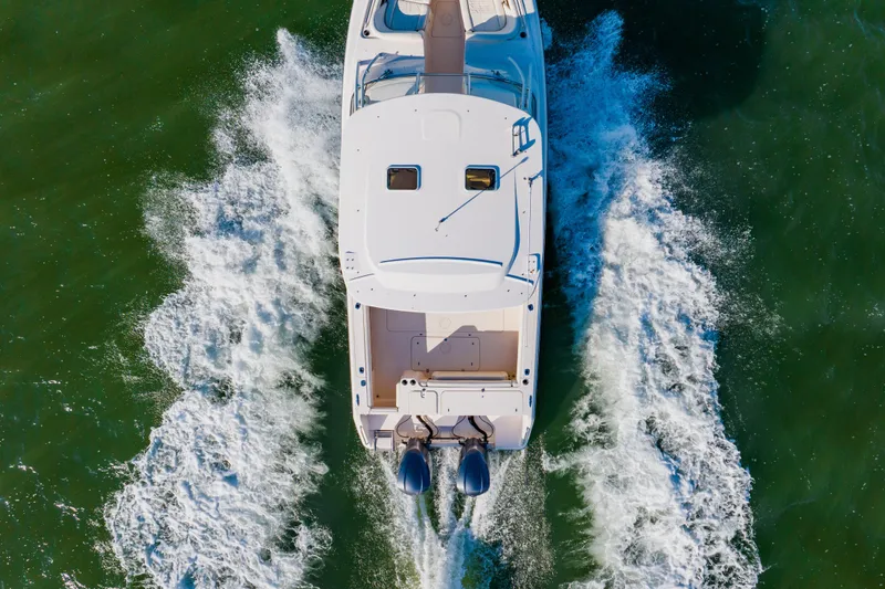  Yacht Photos Pics Aerial view of 2013 Grady-White Freedom 335 boat cruising on water.