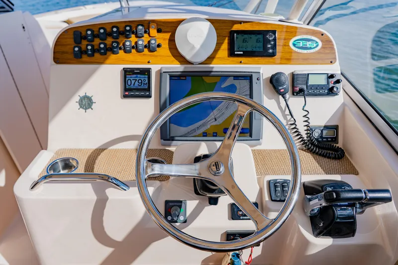  Yacht Photos Pics 2013 Grady-White Freedom 335 helm with navigation controls and steering wheel.