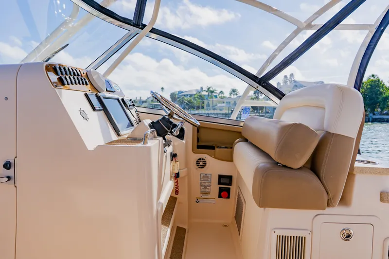  Yacht Photos Pics 2013 Grady-White Freedom 335 boat interior with steering wheel and controls.