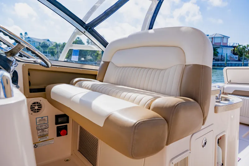  Yacht Photos Pics 2013 Grady-White Freedom 335 boat interior with luxurious seating and steering wheel.