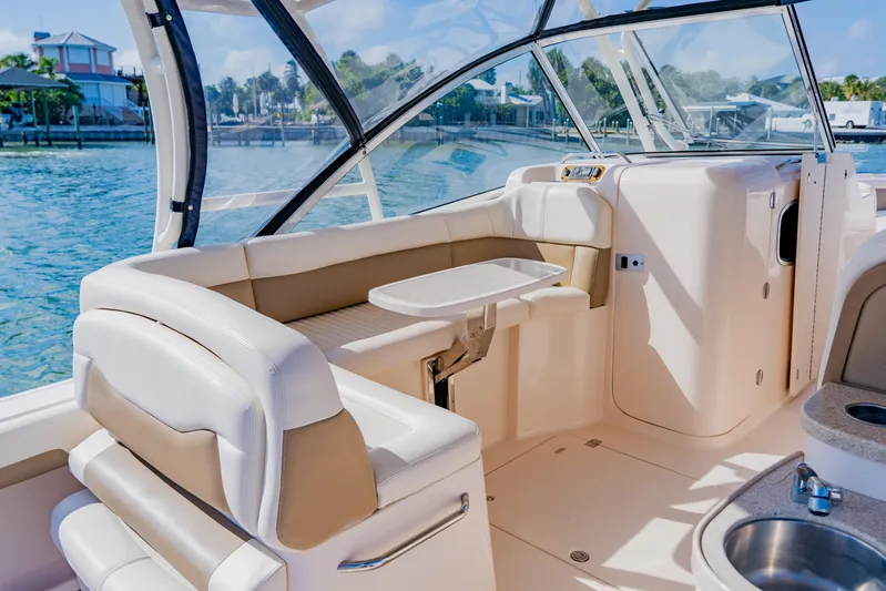  Yacht Photos Pics 2013 Grady-White Freedom 335 boat interior with seating and table, dockside view.
