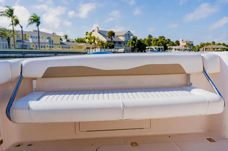  Yacht Photos Pics White seating on 2013 Grady-White Freedom 335 boat, with waterfront homes in background.