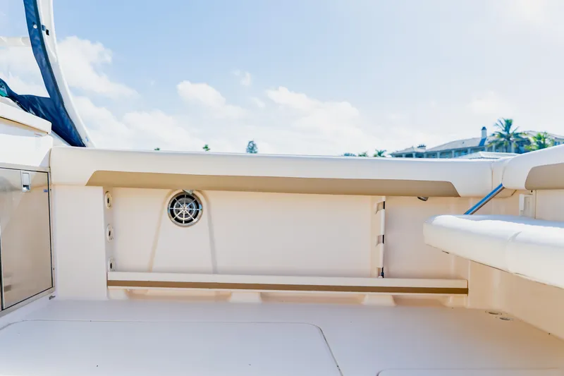 Yacht Photos Pics 2013 Grady-White Freedom 335 boat interior with seating and storage, under clear blue sky.