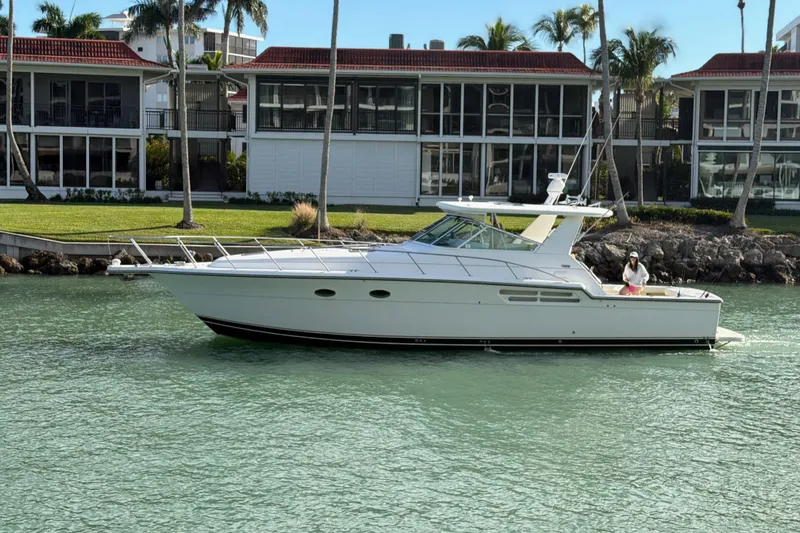  Yacht Photos Pics 2001 Tiara Yachts 4300 Open cruising near waterfront homes with palm trees.