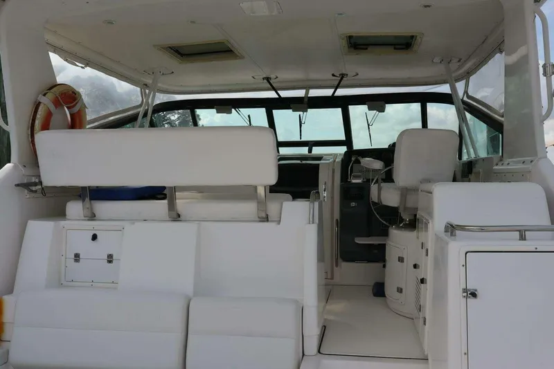  Yacht Photos Pics Interior view of a 2001 Tiara Yachts 4300 Open, featuring white seating and helm area.
