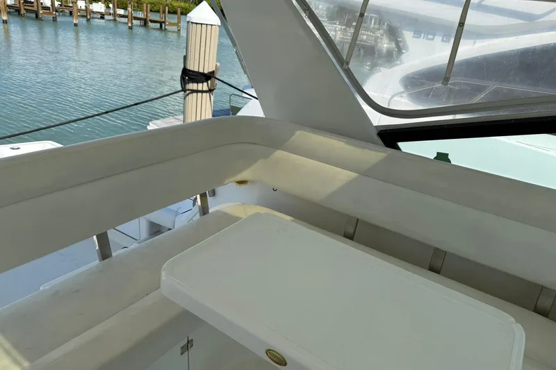  Yacht Photos Pics Interior view of 2001 Tiara Yachts 4300 Open, featuring seating and table by the water.