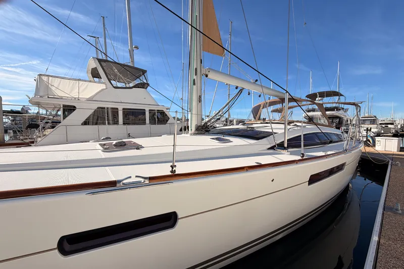 Joie Yacht Photos Pics 2011 Jeanneau 53 sailboat docked in marina under clear blue sky.