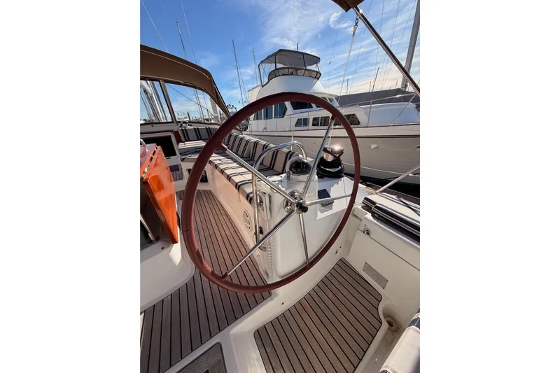 Joie Yacht Photos Pics Steering wheel of a 2011 Jeanneau 53 yacht, docked at a marina.