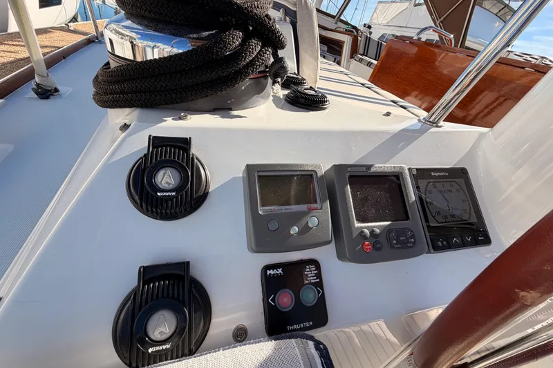Joie Yacht Photos Pics Control panel of a 2011 Jeanneau 53 sailboat with navigation instruments and winch.