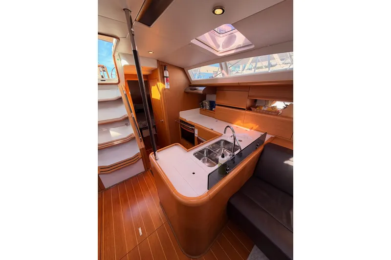 Joie Yacht Photos Pics Interior of 2011 Jeanneau 53 yacht featuring modern kitchen and seating area.