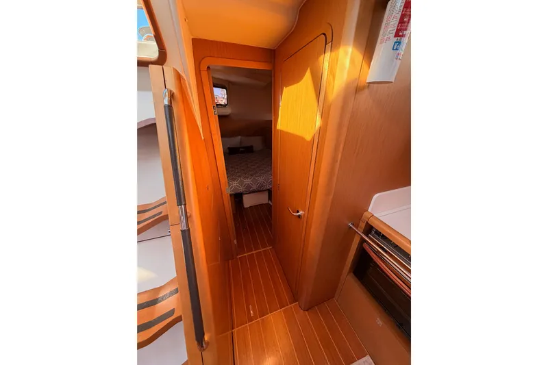 Joie Yacht Photos Pics Interior of 2011 Jeanneau 53 yacht, featuring a cozy cabin and wooden flooring.