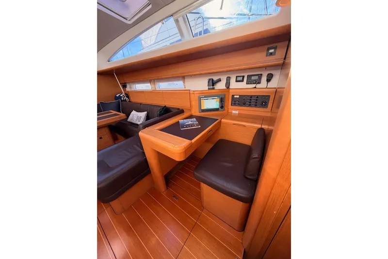 Joie Yacht Photos Pics Interior of 2011 Jeanneau 53 yacht with navigation station and wooden finish.