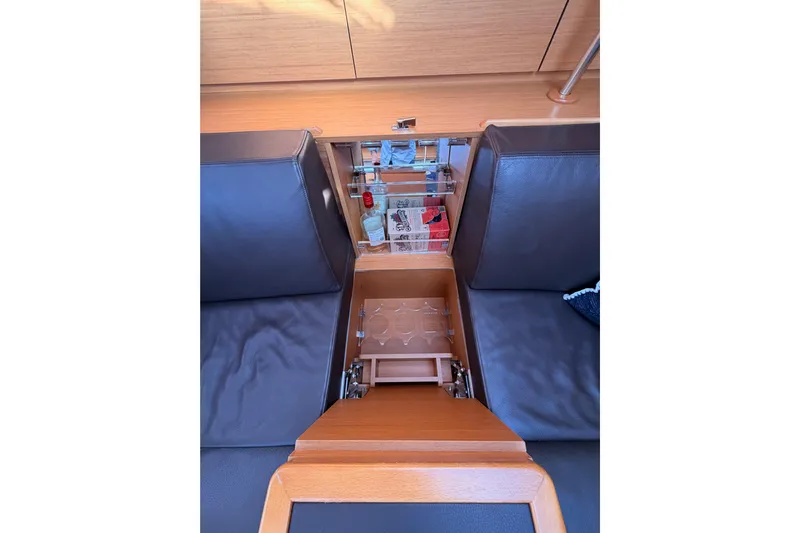 Joie Yacht Photos Pics Interior of 2011 Jeanneau 53 yacht with built-in storage and seating area.