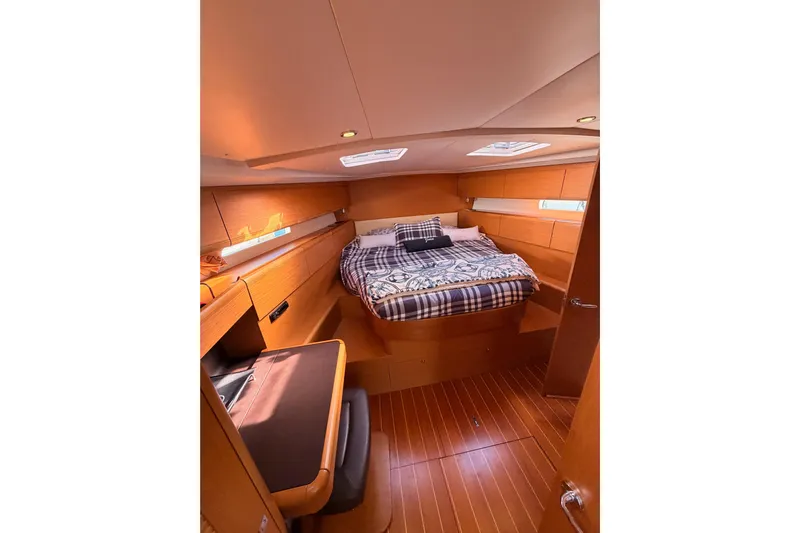 Joie Yacht Photos Pics Luxurious cabin interior of 2011 Jeanneau 53 yacht with cozy bed and wooden finish.