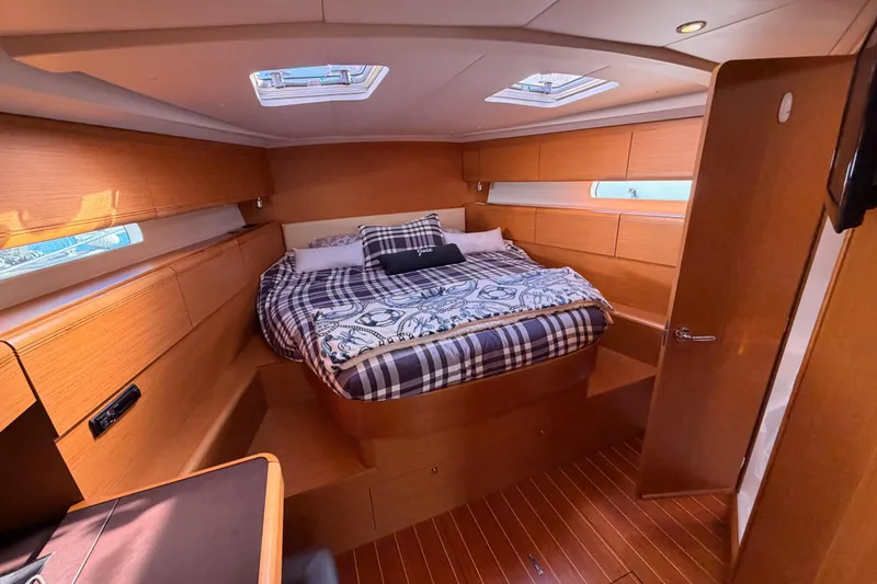 Joie Yacht Photos Pics Luxurious 2011 Jeanneau 53 yacht cabin with cozy bed and elegant wood finish.
