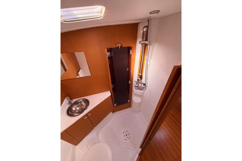 Joie Yacht Photos Pics Luxurious bathroom in 2011 Jeanneau 53 yacht with modern fixtures and wooden cabinetry.