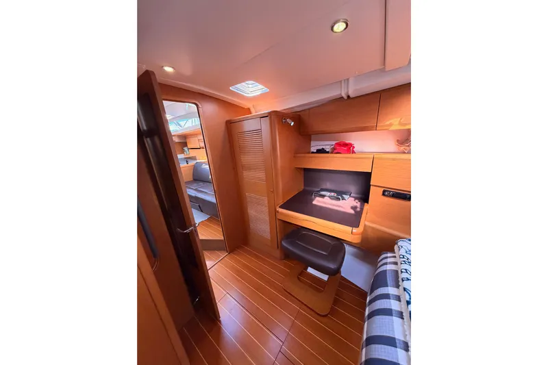 Joie Yacht Photos Pics Interior of 2011 Jeanneau 53 yacht, featuring wooden flooring and cozy seating area.