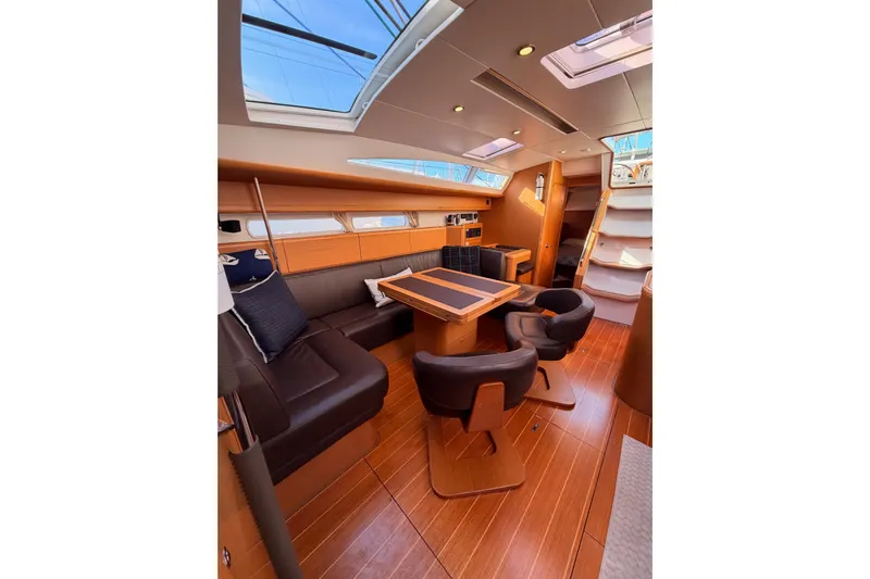 Joie Yacht Photos Pics Luxurious interior of 2011 Jeanneau 53 yacht with elegant seating and wooden flooring.