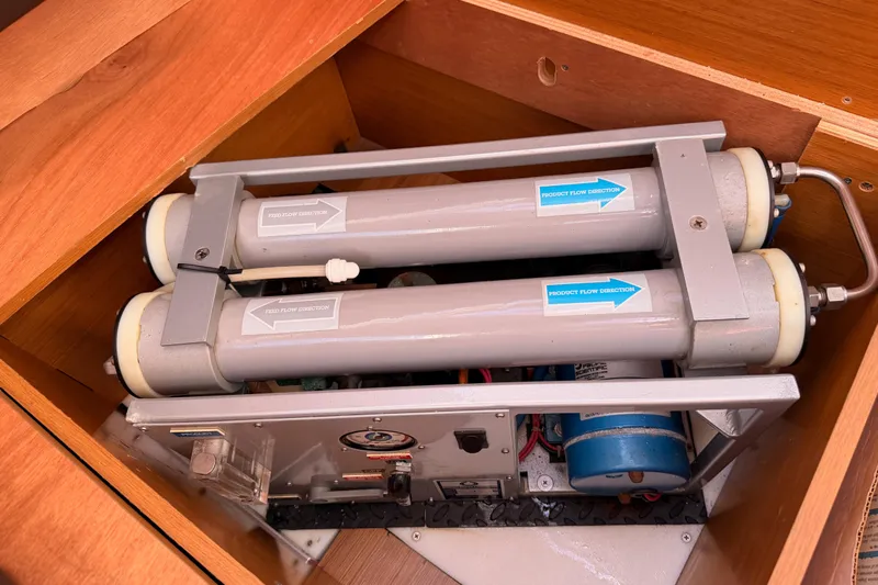 Joie Yacht Photos Pics Water filtration system inside a 2011 Jeanneau 53 yacht, showcasing flow direction indicators.