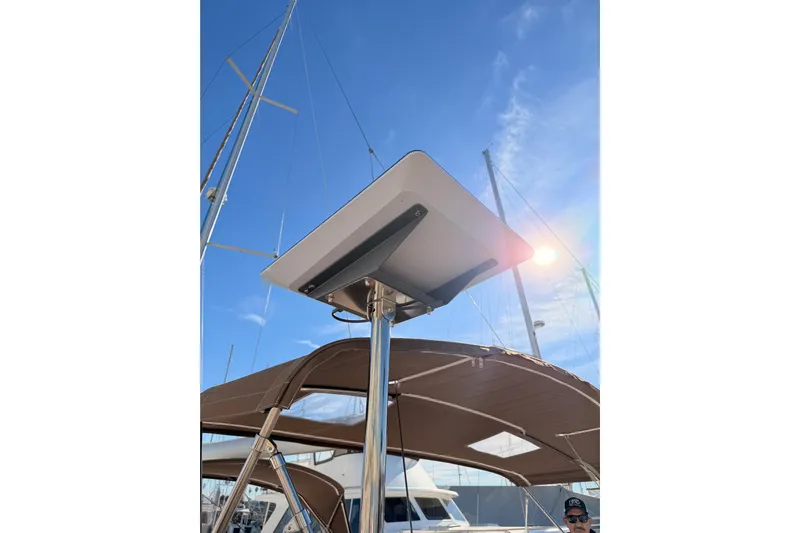 Joie Yacht Photos Pics Satellite dish on Jeanneau 53 sailboat, 2011 model, under clear blue sky.