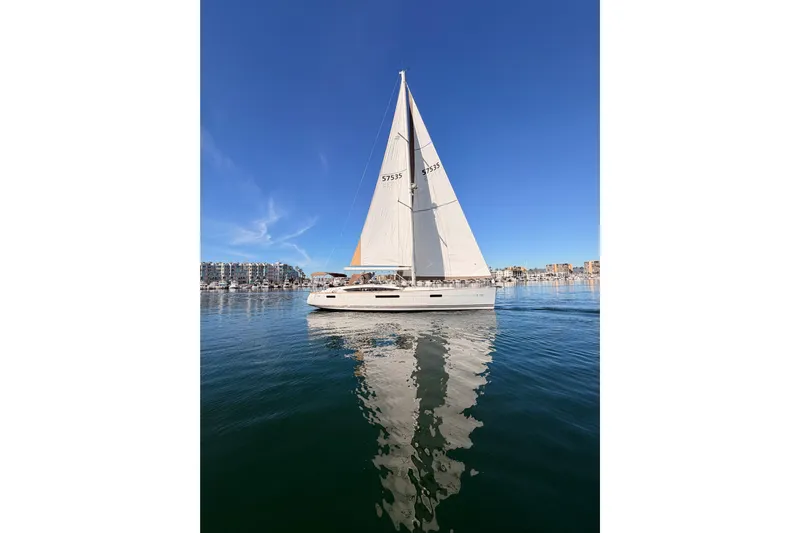 Joie Yacht Photos Pics 2011 Jeanneau 53 sailboat on calm water under clear blue sky.