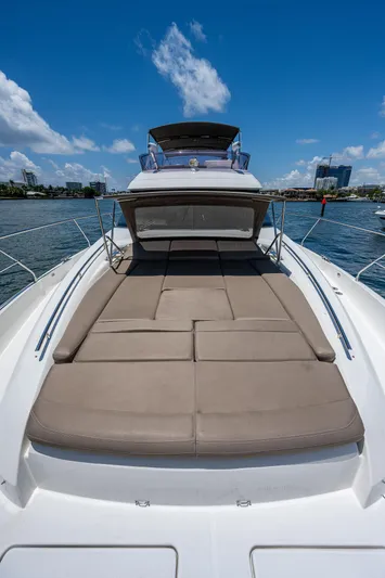  Yacht Photos Pics 2014 Prestige 550 yacht with spacious sun deck under clear blue sky.