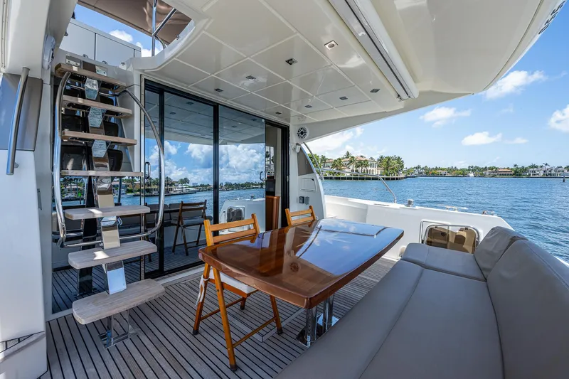  Yacht Photos Pics Luxurious 2014 Prestige 550 yacht deck with dining area and scenic water view.