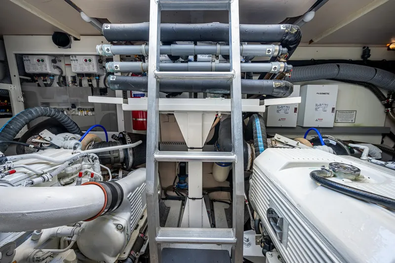  Yacht Photos Pics Engine room of 2014 Prestige 550 yacht with visible machinery and ladder.