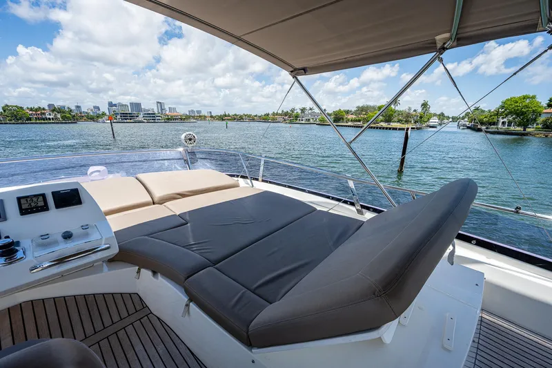  Yacht Photos Pics Luxurious 2014 Prestige 550 yacht deck with sun loungers, overlooking scenic waterfront views.