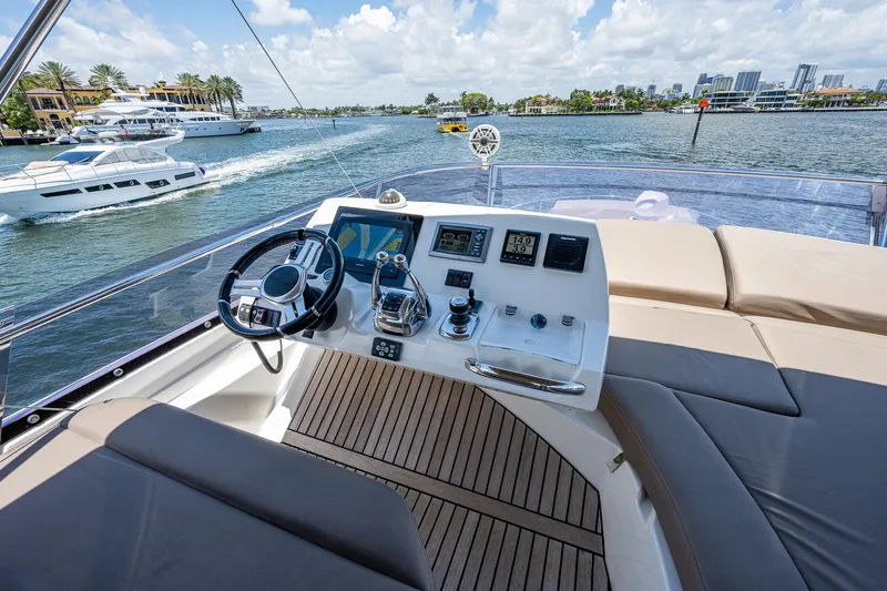  Yacht Photos Pics Prestige 550 yacht helm, 2014 model, with luxurious seating and scenic waterfront view.