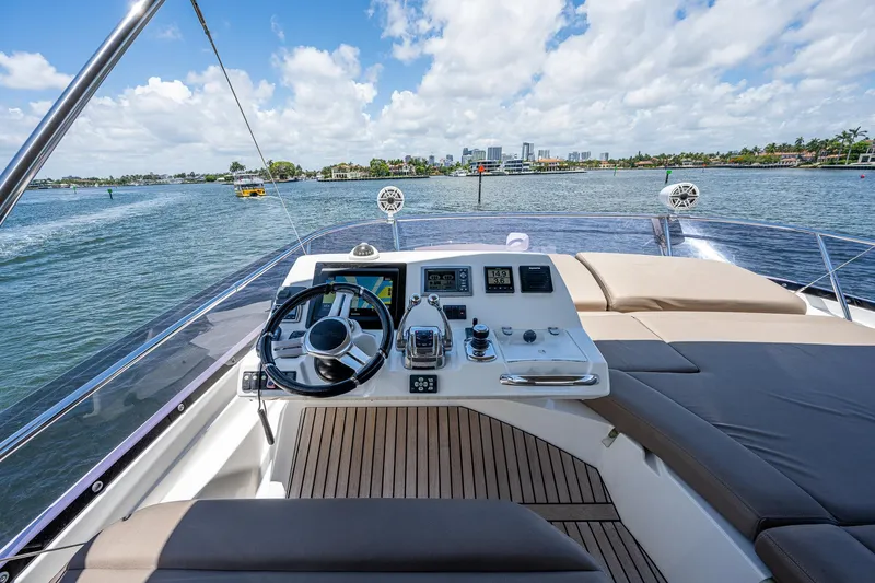  Yacht Photos Pics 2014 Prestige 550 yacht helm with luxurious seating and scenic water view.