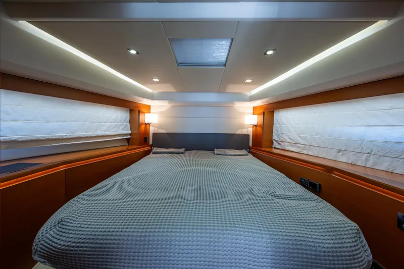  Yacht Photos Pics Luxurious bedroom interior of 2014 Prestige 550 yacht with modern lighting and cozy bedding.