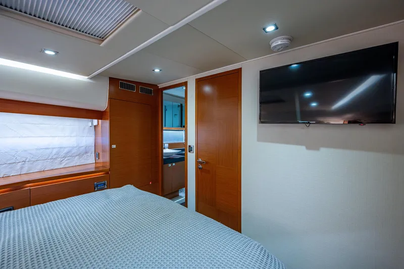  Yacht Photos Pics Luxurious 2014 Prestige 550 yacht bedroom with TV and modern decor.