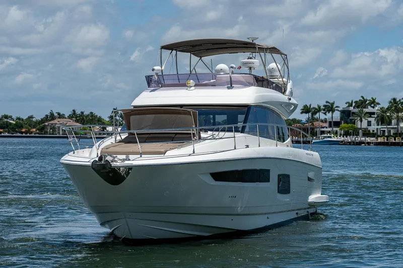 Yacht Photos Pics Luxurious 2014 Prestige 550 yacht cruising on a sunny day, with scenic waterfront views.