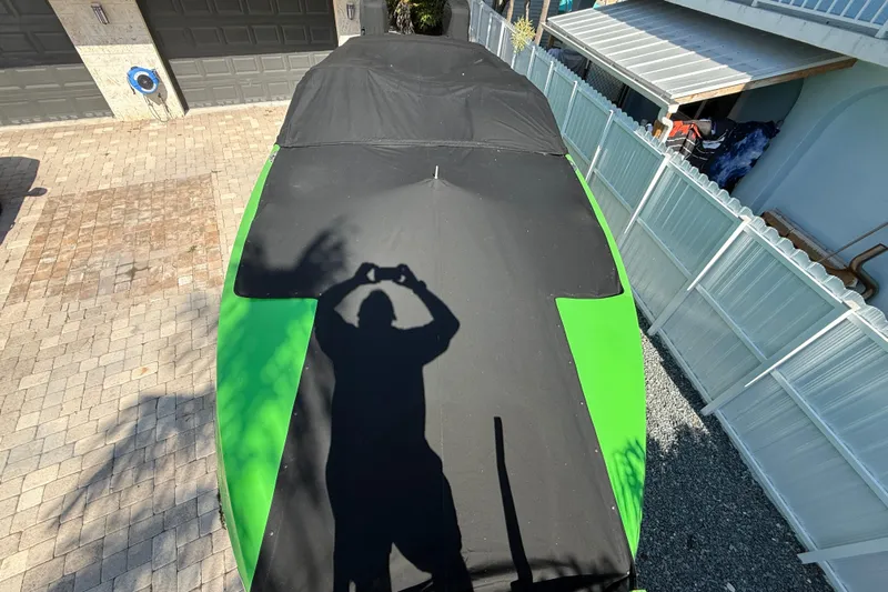  Yacht Photos Pics Shadow on covered E-Ticket 29 boat, 2021 model, parked in driveway.