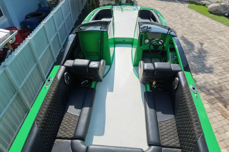  Yacht Photos Pics 2021 E-Ticket 29 boat with green and black interior, featuring spacious seating and modern controls.