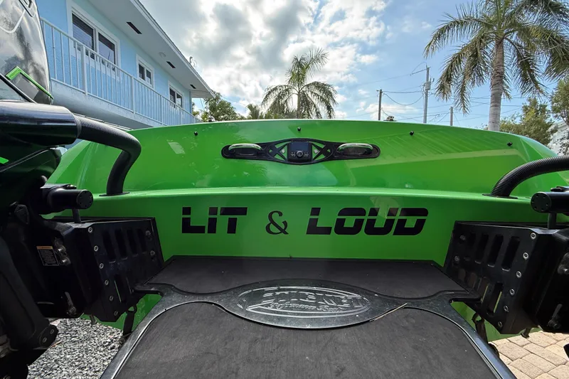  Yacht Photos Pics Green 2021 E-Ticket 29 boat with "Lit & Loud" text, palm trees in background.