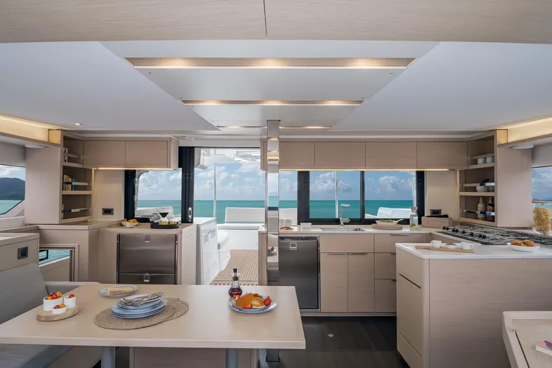  Yacht Photos Pics Modern interior of 2021 Lagoon 46 yacht with ocean view and elegant kitchen design.