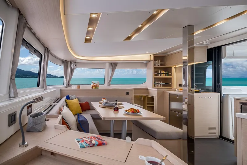  Yacht Photos Pics Luxurious interior of 2021 Lagoon 46 yacht with ocean view and modern dining area.