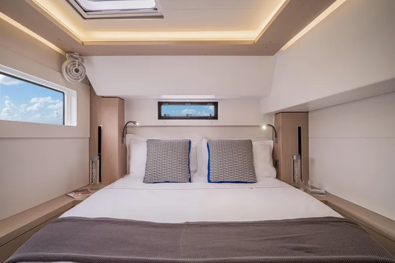  Yacht Photos Pics Luxurious bedroom interior of 2021 Lagoon 46 yacht with modern design and natural light.