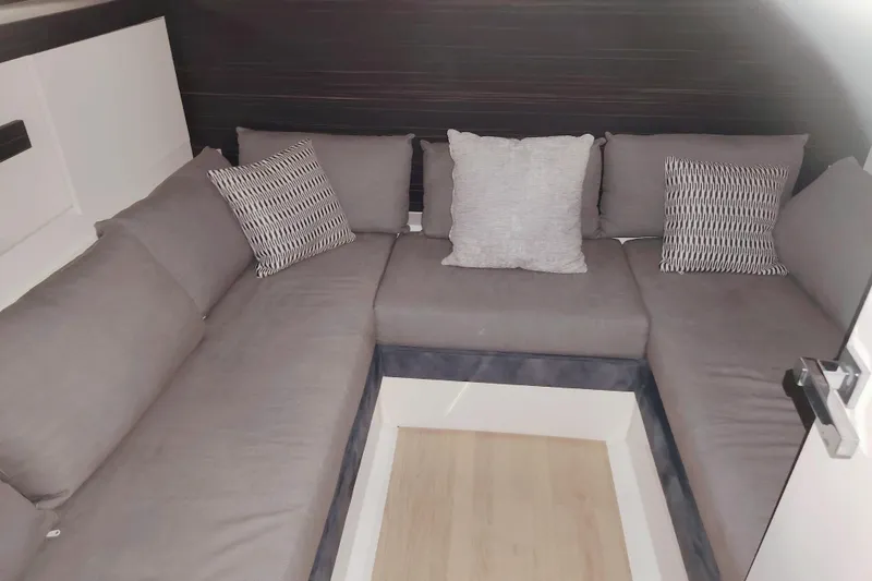 Yacht Photos Pics 2024 Fiart Seawalker 39 interior with gray cushioned seating and decorative pillows.