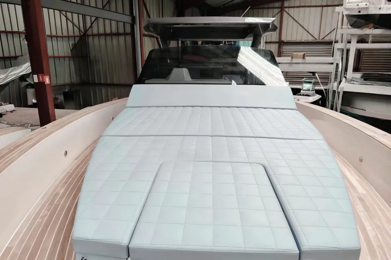  Yacht Photos Pics 2024 Fiart Seawalker 39 luxury yacht with spacious sunbed in a boatyard setting.