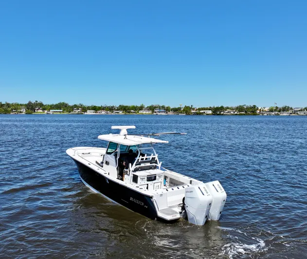  Yacht Photos Pics 2024 Blackfin 332 CC boat cruising on a sunny day in open water.